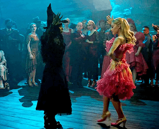Galinda and Elphaba doing an awkward dance in Wicked